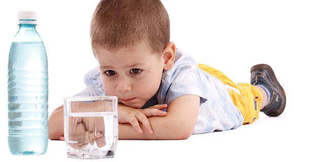 Child infront of water glas
